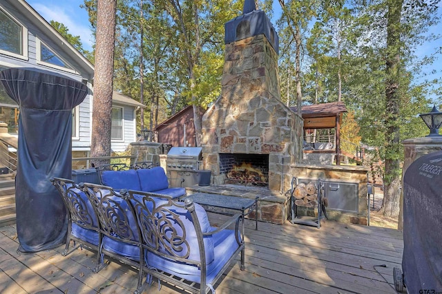 wooden deck featuring grilling area and an outdoor living space with a fireplace