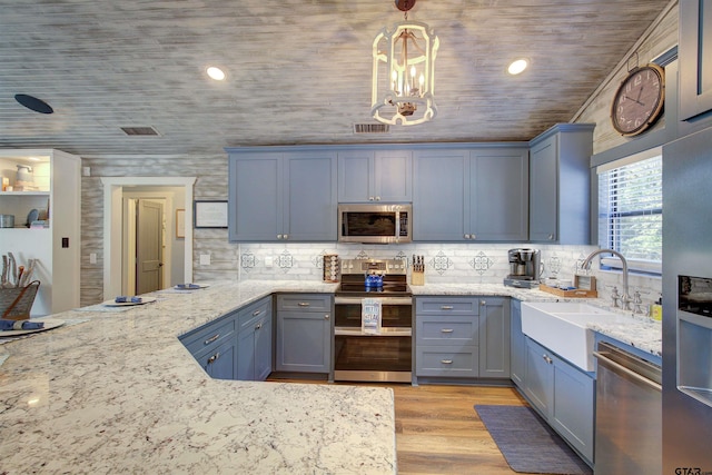 kitchen featuring sink, wooden ceiling, pendant lighting, stainless steel appliances, and light stone countertops