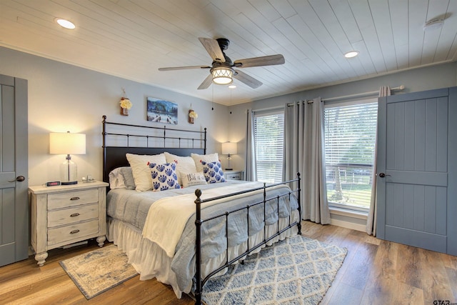 bedroom featuring crown molding, wood ceiling, ceiling fan, and light wood-type flooring