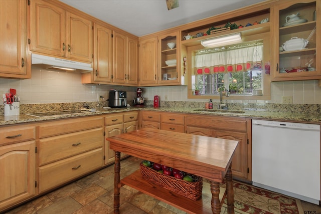 kitchen featuring dishwasher, cooktop, sink, and light stone counters