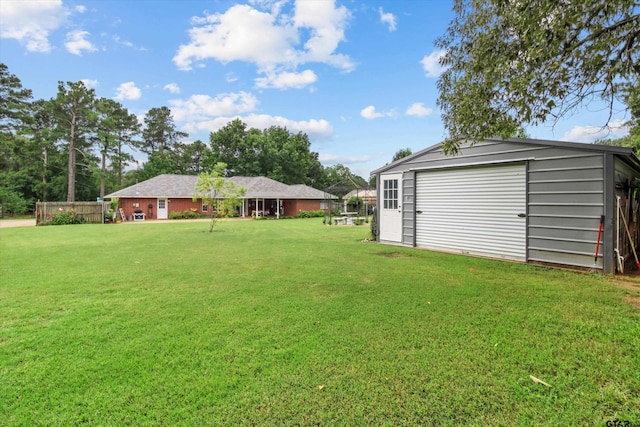 view of yard featuring a garage and an outdoor structure