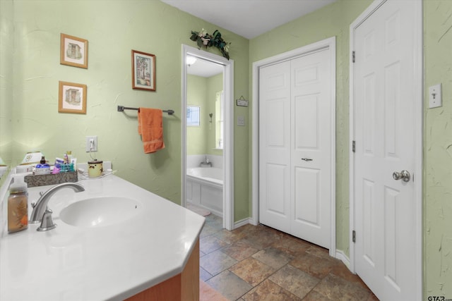 bathroom with vanity and a tub