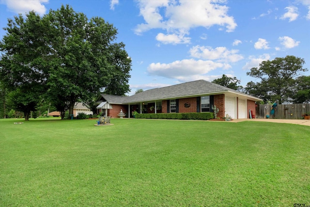 ranch-style home with a garage and a front yard