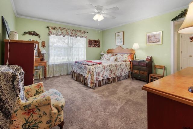 carpeted bedroom featuring ornamental molding and ceiling fan