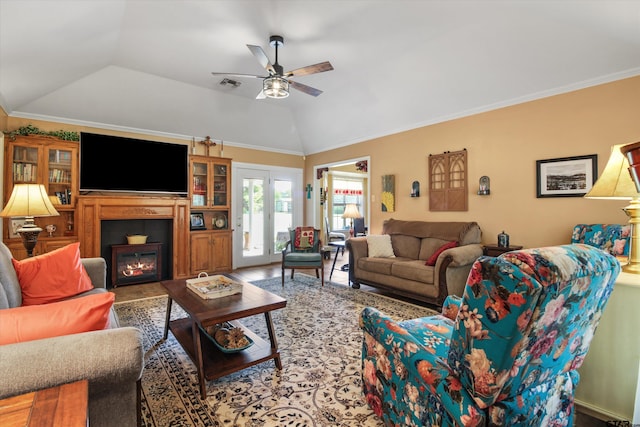 living room featuring ceiling fan, lofted ceiling, wood-type flooring, and ornamental molding