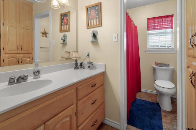 bathroom featuring vanity and toilet