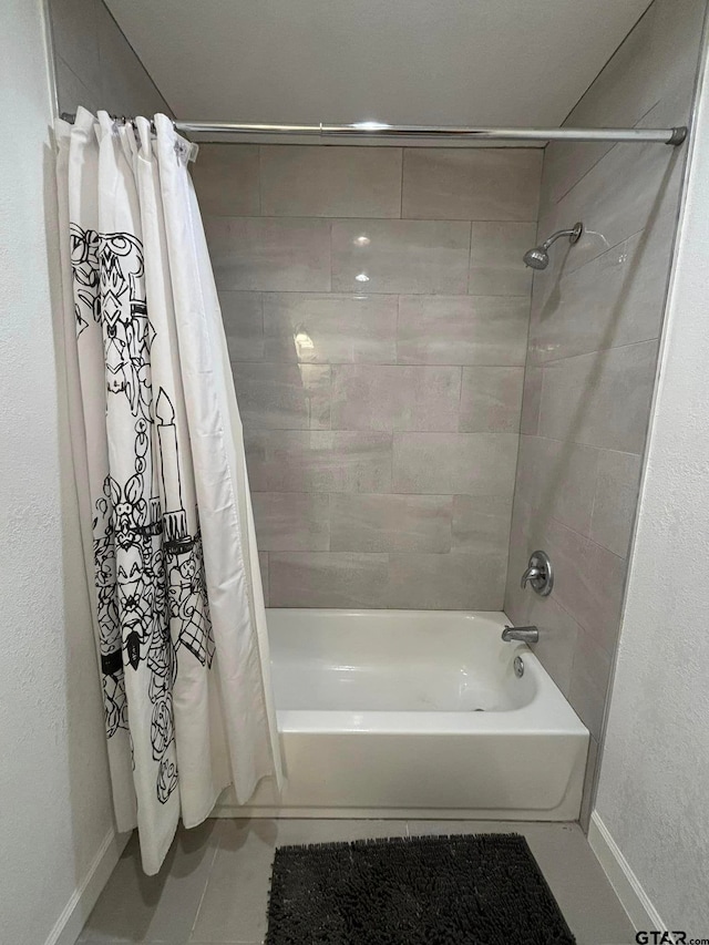 bathroom featuring tile patterned floors and shower / bathtub combination with curtain