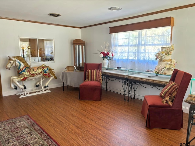 living area featuring hardwood / wood-style flooring and crown molding