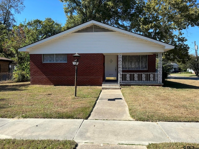 bungalow-style house with a porch and a front yard