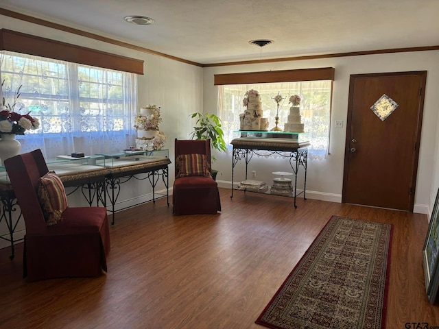 foyer with hardwood / wood-style floors and crown molding