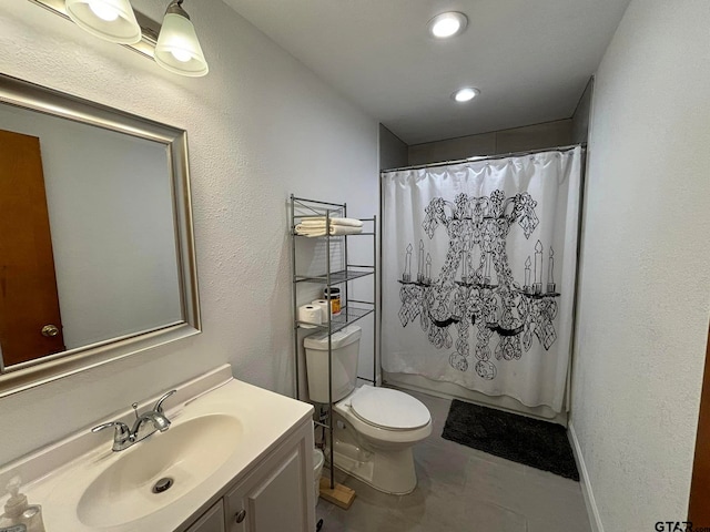 bathroom with tile patterned floors, vanity, and toilet