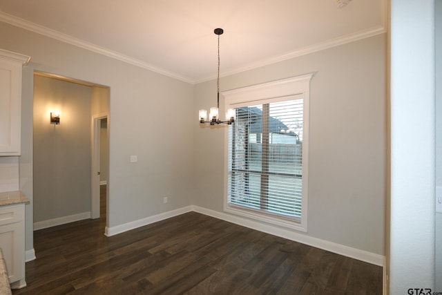 unfurnished dining area featuring dark wood-type flooring, crown molding, and a notable chandelier