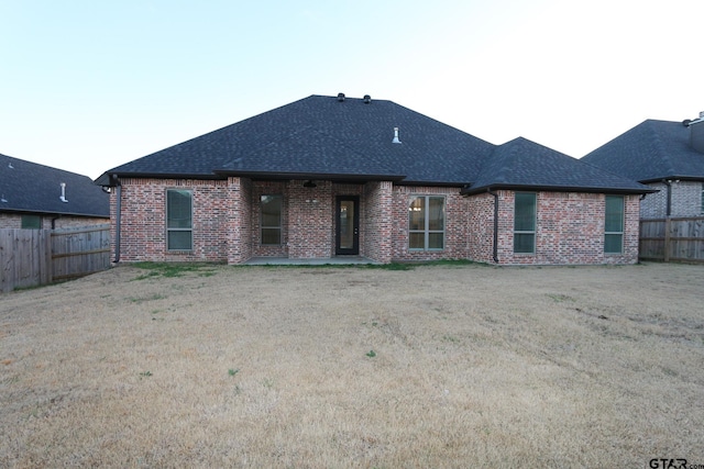 back of property featuring a yard and a patio