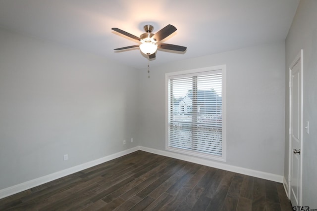 empty room featuring dark wood-type flooring and ceiling fan