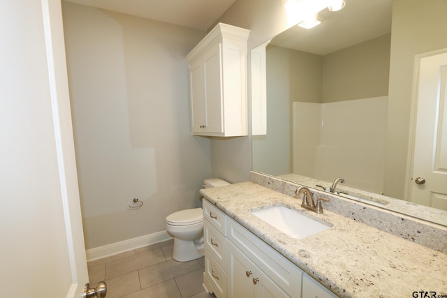 bathroom featuring vanity, tile patterned floors, and toilet