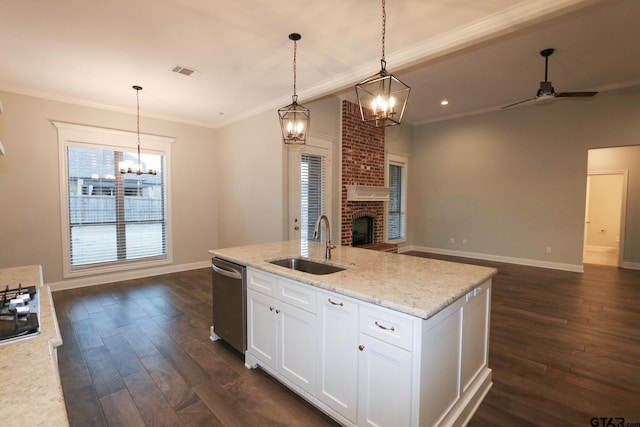 kitchen featuring decorative light fixtures, dishwasher, sink, and white cabinets