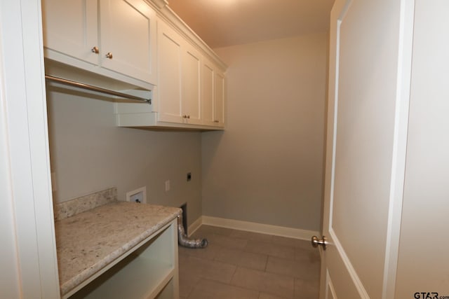 washroom with electric dryer hookup, washer hookup, tile patterned floors, and cabinets