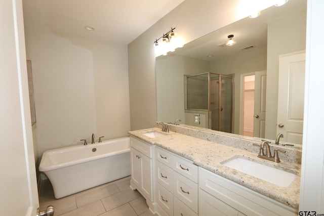 bathroom featuring vanity, independent shower and bath, and tile patterned flooring