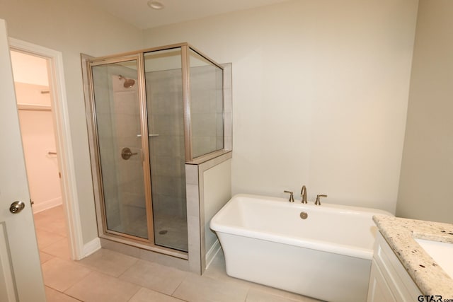 bathroom with vanity, tile patterned floors, and plus walk in shower