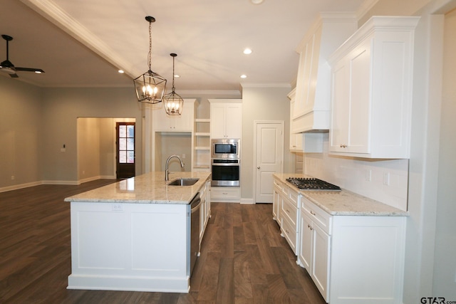 kitchen with stainless steel appliances, a kitchen island with sink, and white cabinets