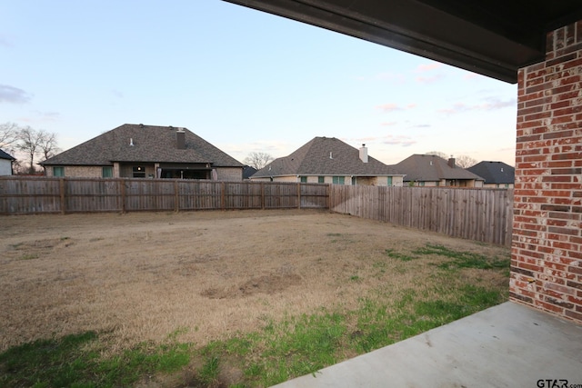 view of yard at dusk