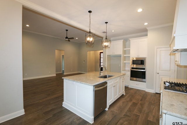 kitchen featuring appliances with stainless steel finishes, white cabinetry, sink, a kitchen island with sink, and light stone countertops