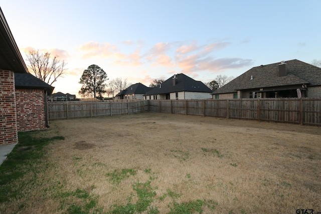 view of yard at dusk