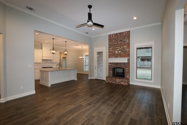 unfurnished living room featuring dark hardwood / wood-style flooring, a fireplace, plenty of natural light, and ceiling fan