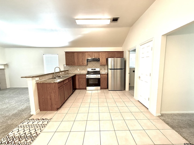 kitchen with under cabinet range hood, light carpet, stainless steel appliances, a peninsula, and a sink