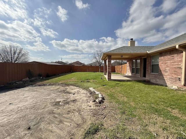 view of yard featuring a patio area and a fenced backyard