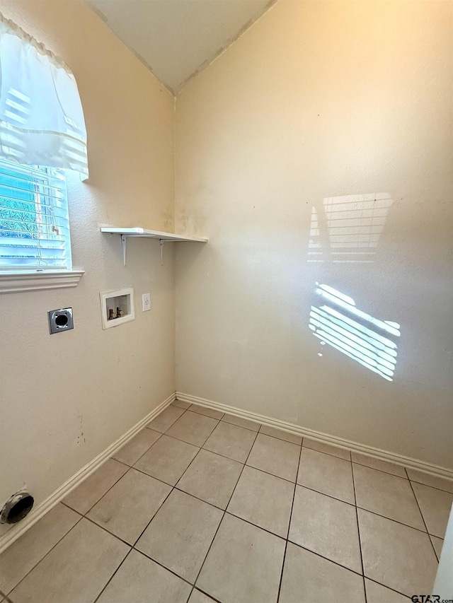 laundry room with electric dryer hookup, hookup for a washing machine, and light tile patterned floors