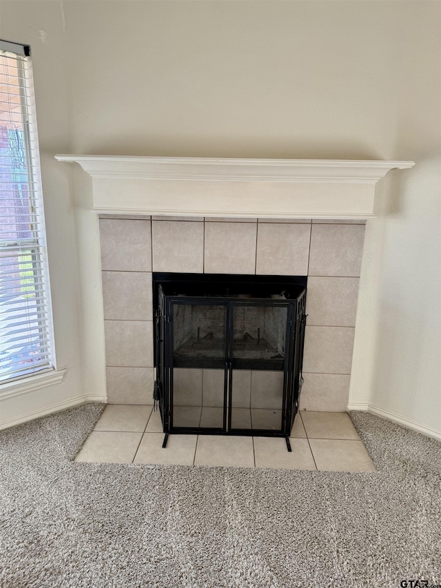 interior details featuring carpet flooring, a fireplace, and baseboards