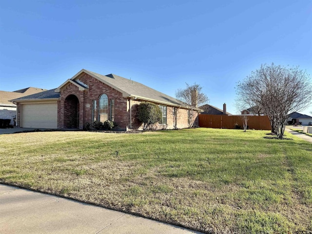 view of front of property featuring an attached garage, brick siding, fence, and a front lawn