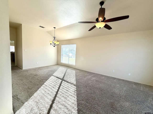 carpeted spare room with lofted ceiling, a textured ceiling, ceiling fan with notable chandelier, visible vents, and baseboards