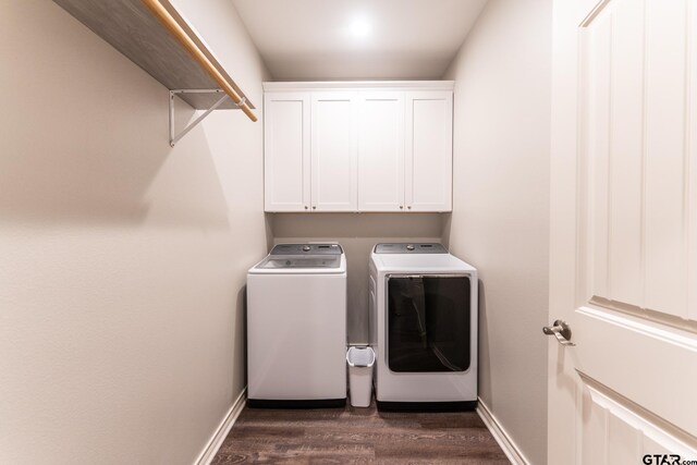 2014 Koby Cir, Sulphur Springs, TX 75482 - washroom with washer and clothes dryer, cabinet space, dark wood-style flooring, and baseboards