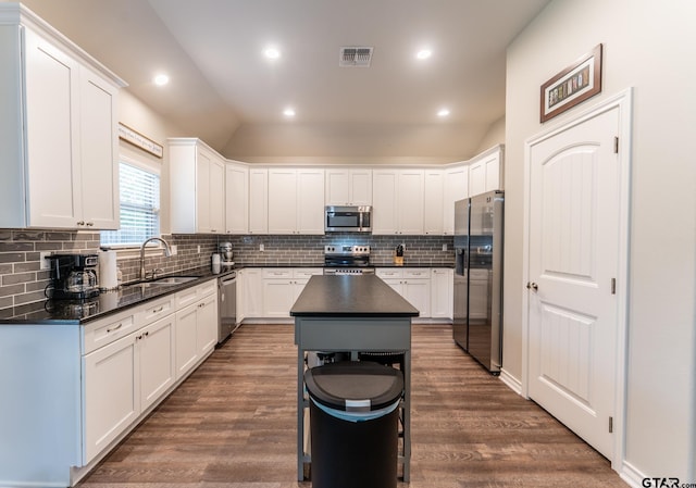 2014 Koby Cir, Sulphur Springs, TX 75482 - kitchen featuring stainless steel appliances, a sink, lofted ceiling, backsplash, and white cabinets
