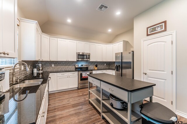 2014 Koby Cir, Sulphur Springs, TX 75482 - kitchen featuring stainless steel appliances, a sink, lofted ceiling, tasteful backsplash, and open shelves