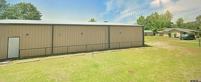 view of outdoor structure featuring a yard