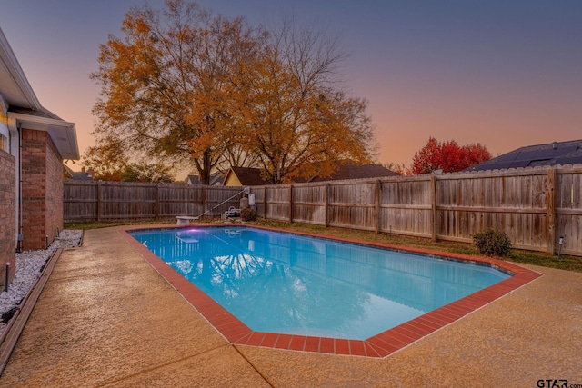 view of pool at dusk