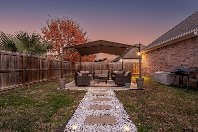 yard at dusk featuring a patio and an outdoor living space