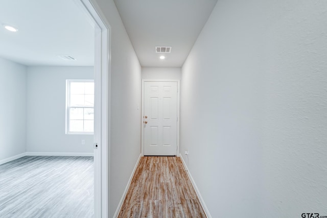 corridor featuring light hardwood / wood-style floors