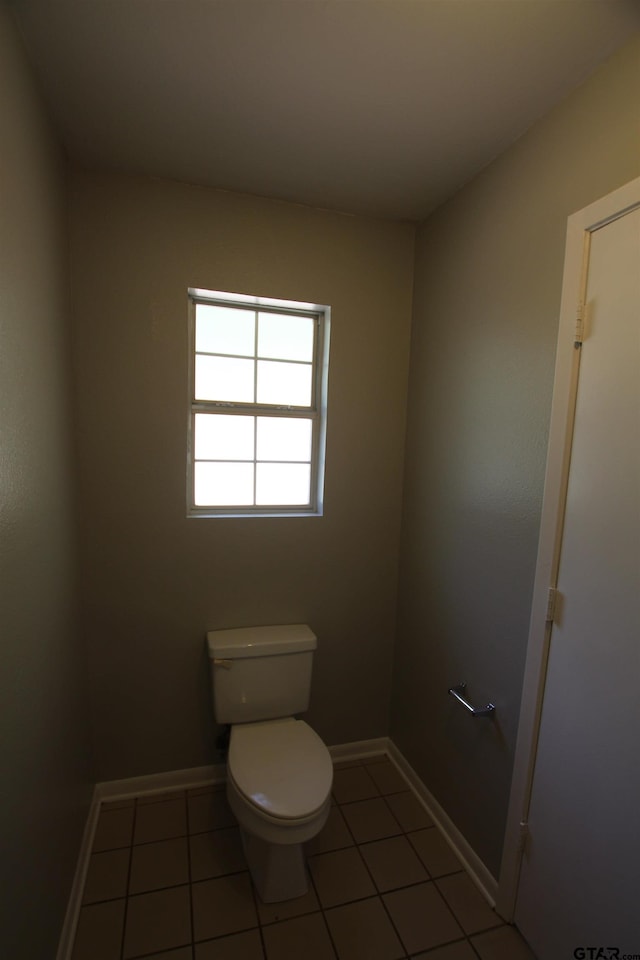 bathroom with toilet and tile patterned floors