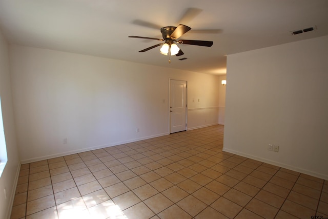 tiled empty room featuring ceiling fan