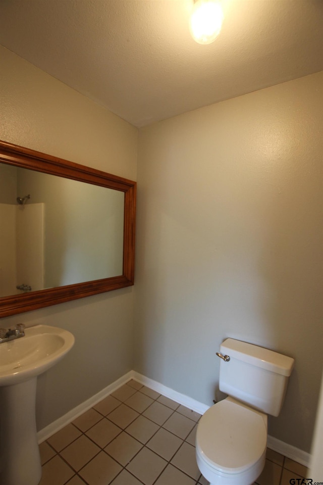 bathroom featuring tile patterned flooring and toilet