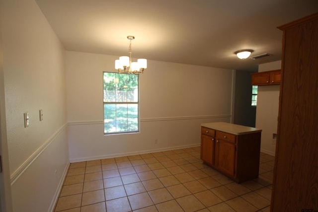 interior space with light tile patterned floors and a notable chandelier