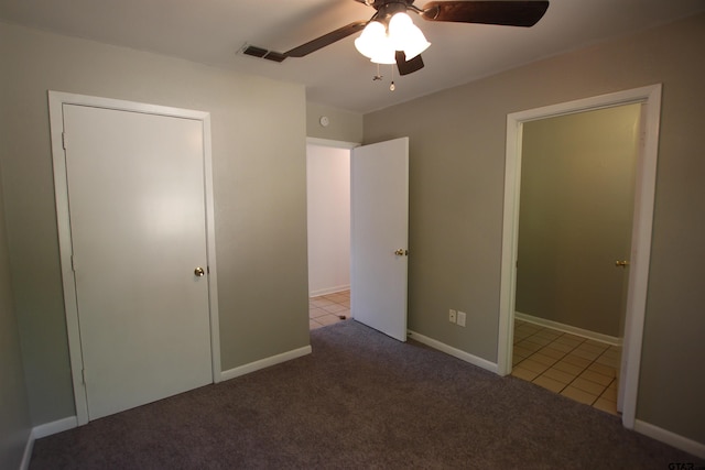 unfurnished bedroom featuring ceiling fan, carpet flooring, and a closet