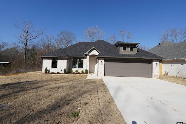 view of front of house with a garage and a front lawn