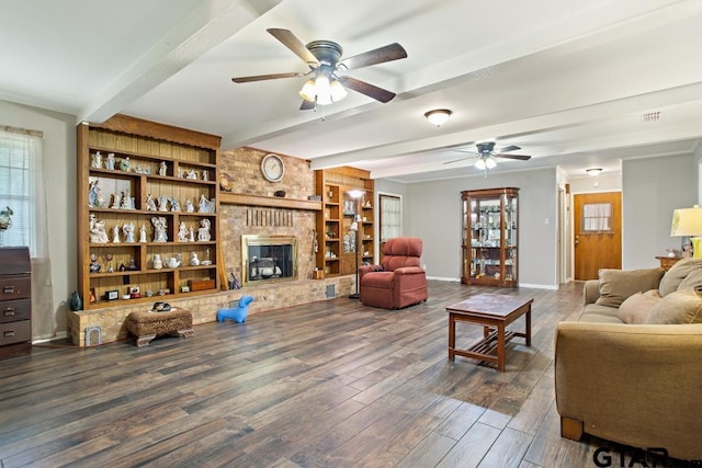10516 Debbie Ln, Flint, TX 75762 - living area featuring ceiling fan, beamed ceiling, dark wood-style floors, a fireplace, and built in shelves