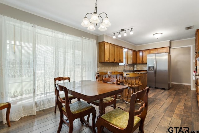 10516 Debbie Ln, Flint, TX 75762 - dining room with dark wood finished floors, a chandelier, and crown molding