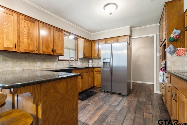 10516 Debbie Ln, Flint, TX 75762 - kitchen featuring stainless steel refrigerator with ice dispenser, brown cabinetry, dark wood finished floors, a peninsula, and crown molding